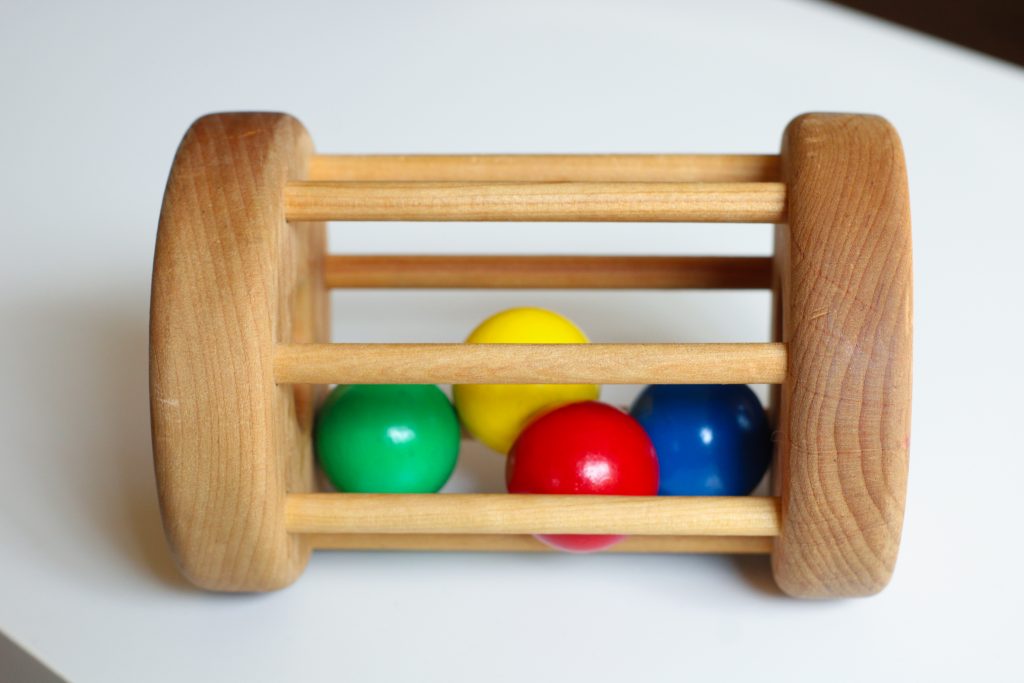 Wooden Cylinder toy with wooden balls inside.