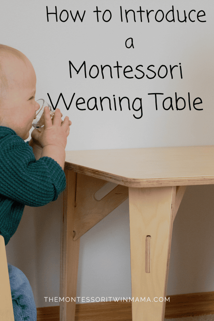 small chid sitting at a small table drinking a glass of water. Text over the image saying "how to introduce a Montessori weaning table"