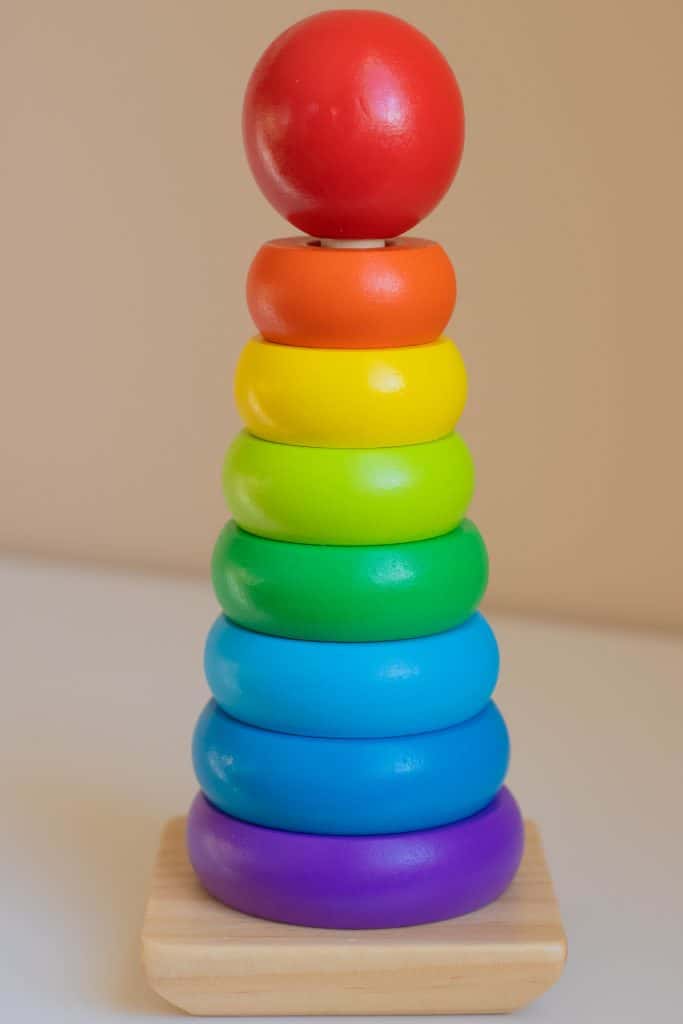 Rainbow wooden disk stacker on a dowel