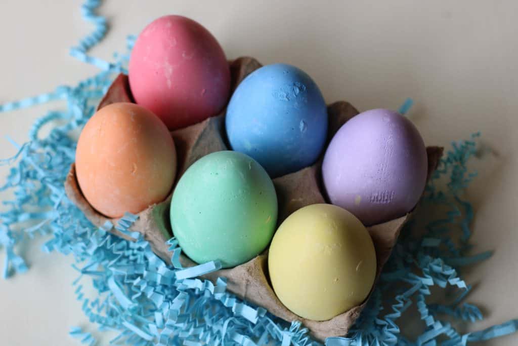 Six chalk eggs in a carton.