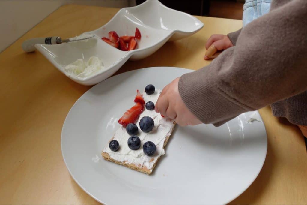 Child making a snack.