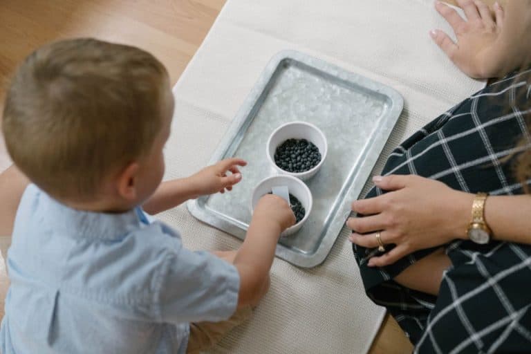 child scooping beans