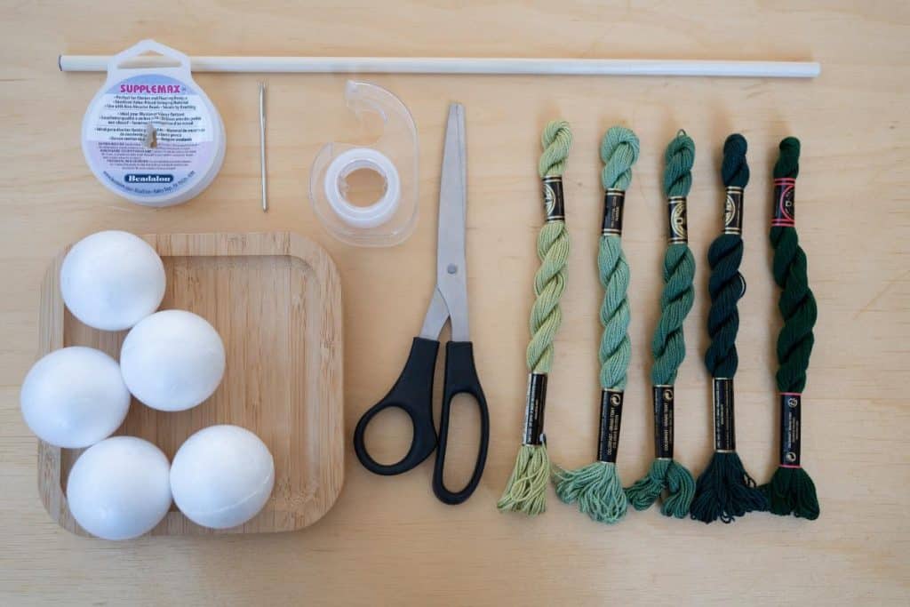 Supplies: balls, string, tape, scissors, embroidery thread.