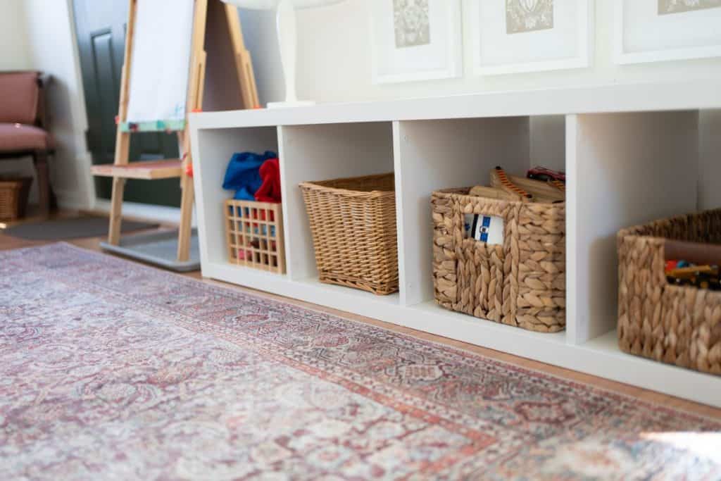 Shelf with baskets of toys.