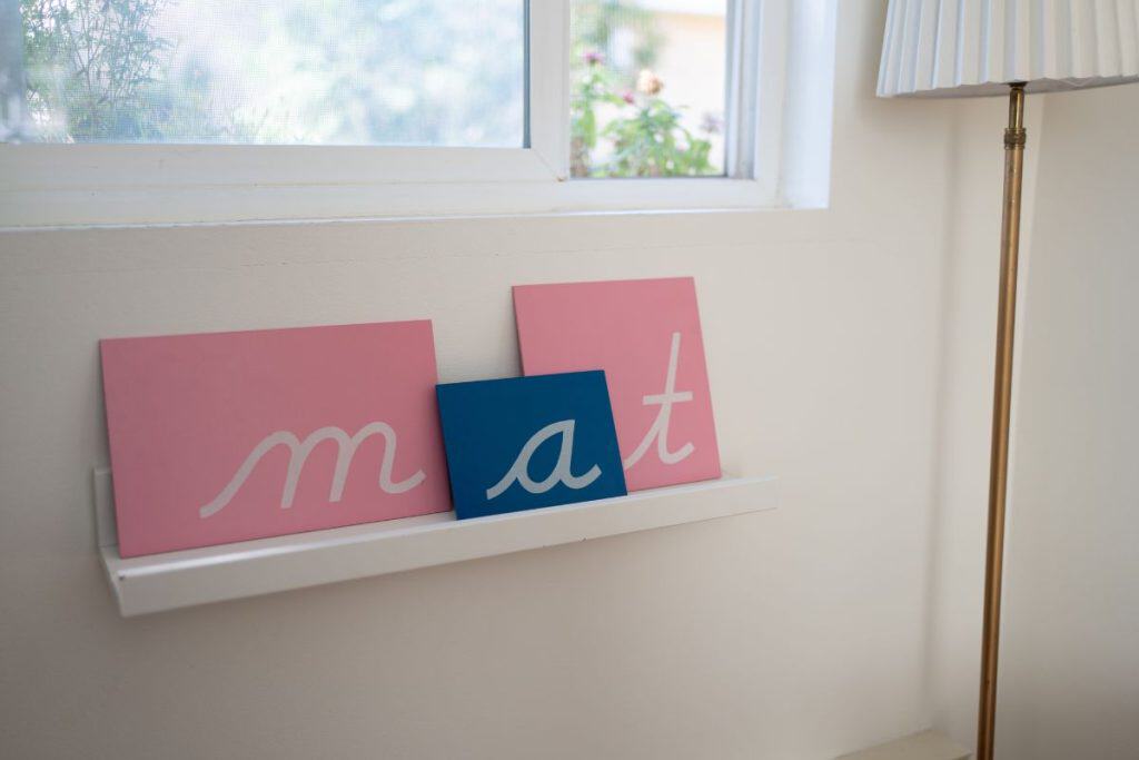 Montessori sandpaper letters m, a, t.